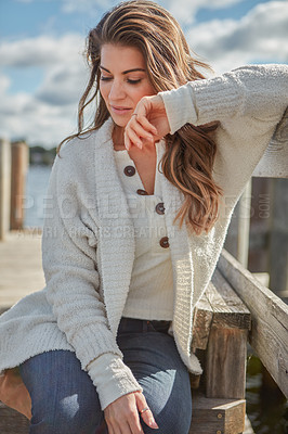 Buy stock photo Shot of a beautiful young woman relaxing outdoors