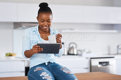 Buy stock photo Coffee, tablet and black woman in kitchen in home reading online celebrity gossip blog. Happy, digital technology and African female person drinking cappuccino in morning on weekend at apartment.