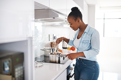 Buy stock photo Black woman, cooking and stove in kitchen, food preparation and stir pot in home. Female person, healthy meal and ingredients for dinner nutrition, heat process and culinary diet for detox wellness