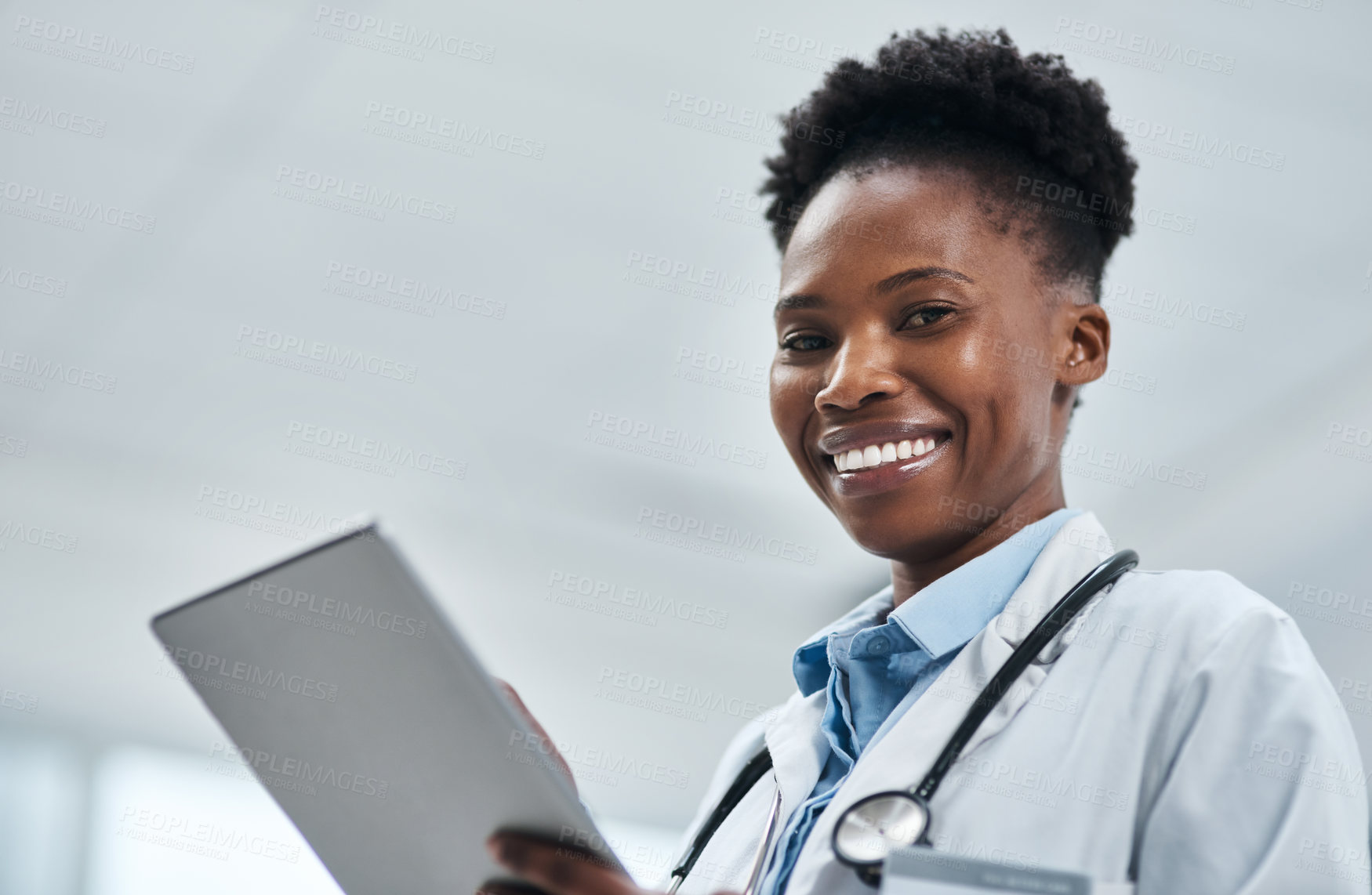 Buy stock photo Portrait of a young doctor using a digital tablet in a hospital