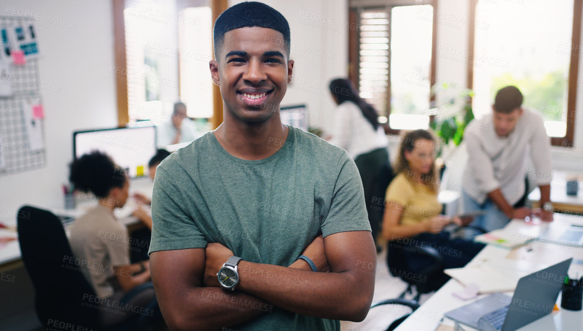 Buy stock photo Portrait of a confident young businessman working in a modern office with his team in the background