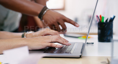 Buy stock photo Shot of an unrecognisable businessman and businesswoman using a laptop in a modern office