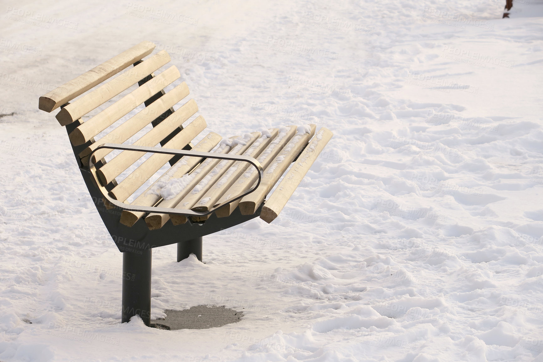 Buy stock photo Empty park bench in snow during winter in Denmark. Public chair in a park covered with snow in cold temperatures outside. Frozen outdoor seat for resting and sitting covered in ice in cold weather