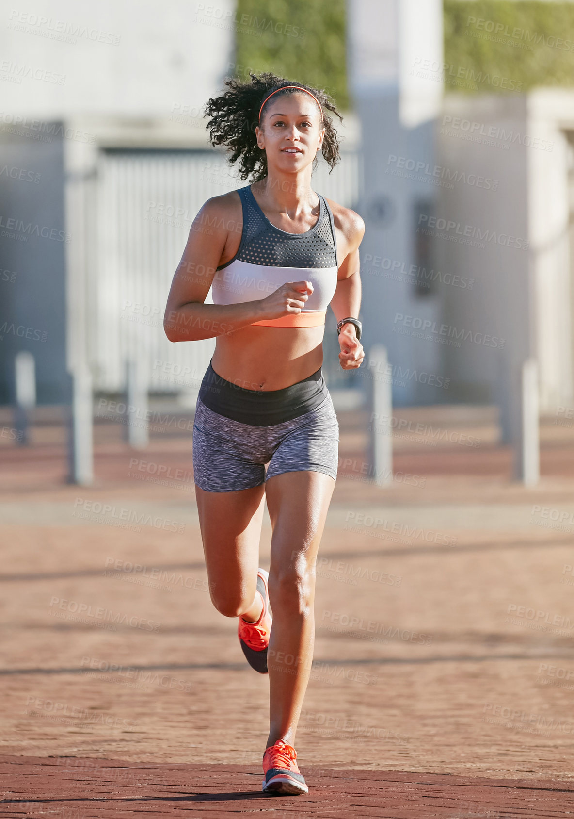 Buy stock photo Full length shot of an attractive young woman taking a run through the city