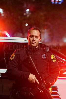 Buy stock photo Cropped portrait of a handsome young policeman standing with his assault rifle while out on patrol