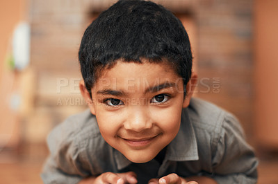 Buy stock photo Portrait of an adorable little boy playing with toy cars at home
