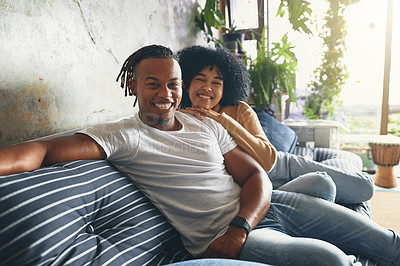 Buy stock photo Portrait of a young couple relaxing together on a sofa at home