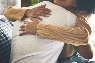 Buy stock photo Closeup shot of a couple hugging each other at home