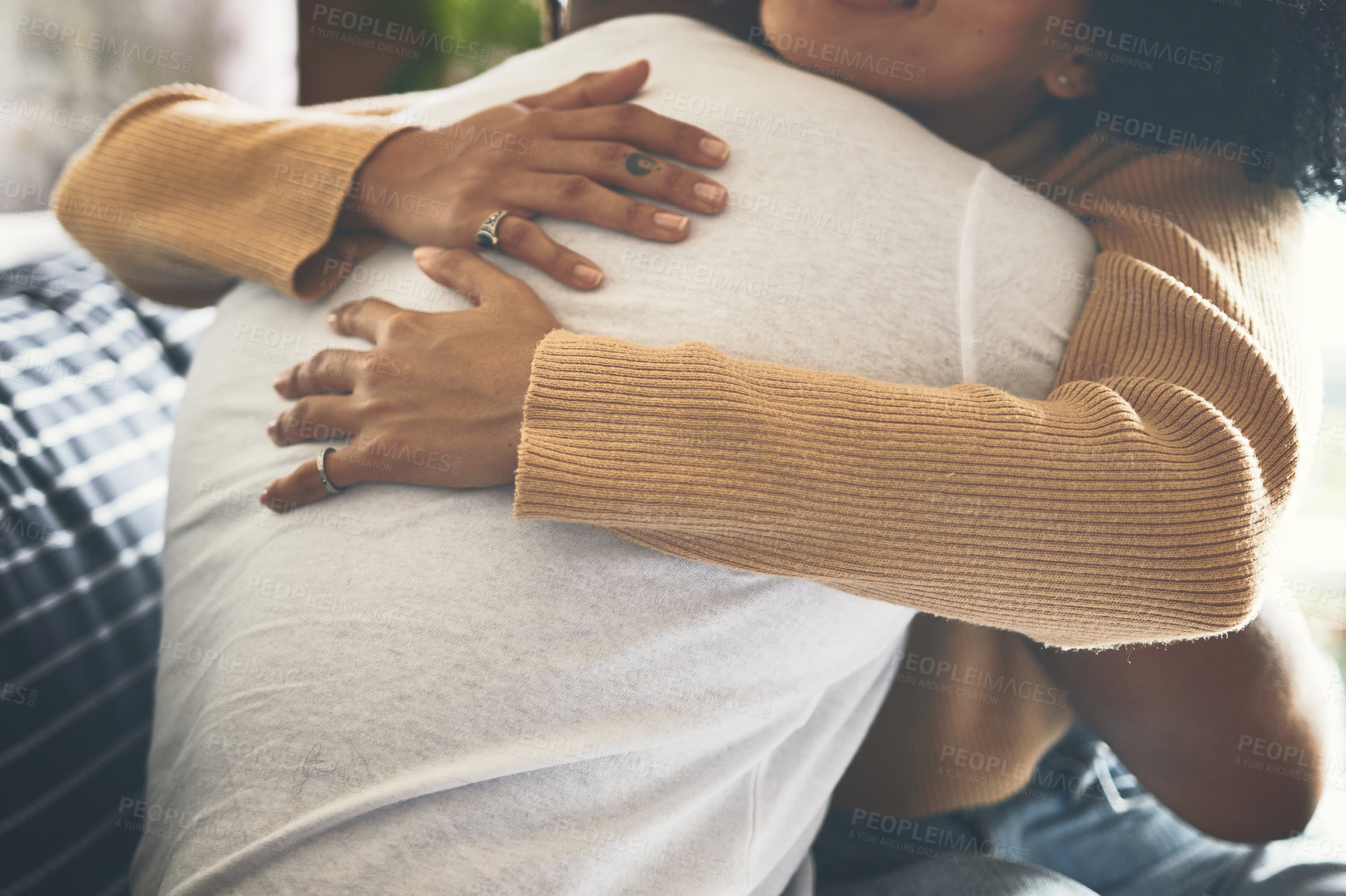 Buy stock photo Closeup shot of a couple hugging each other at home