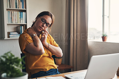 Buy stock photo Shot of a young woman experiencing stress while working from home