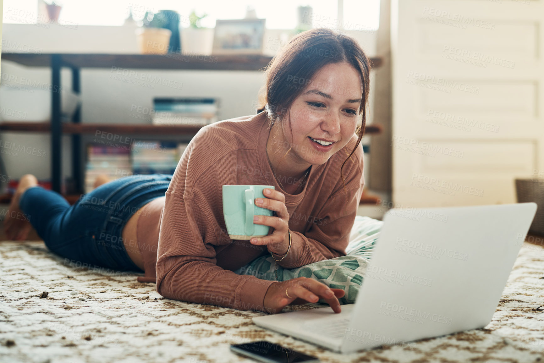 Buy stock photo Woman, laptop and coffee break on floor with communication, typing or social media scroll in home living room. Girl, smile and computer on carpet for chat, tea or cappuccino with internet in lounge