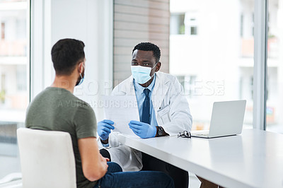Buy stock photo Shot of a masked doctor having a consultation with a man