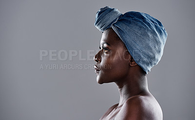 Buy stock photo Shot of a beautiful young woman wearing a denim head wrap while posing against a grey background