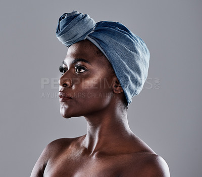 Buy stock photo Shot of a beautiful young woman wearing a denim head wrap while posing against a grey background