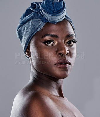 Buy stock photo Shot of a beautiful young woman wearing a denim head wrap while posing against a grey background