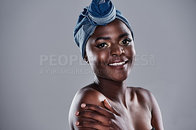 Buy stock photo Shot of a beautiful young woman wearing a denim head wrap while posing against a grey background