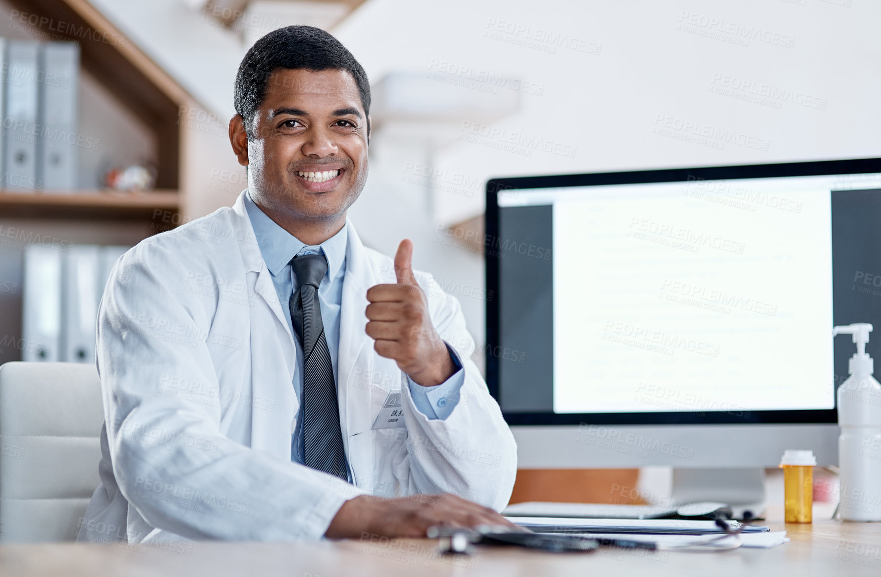 Buy stock photo Doctor, medical practitioner and healthcare worker showing thumbs up for FDA or drug approval in a hospital with blank screen copy space on a computer. GP pleased with clinic success in his office