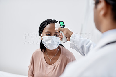 Buy stock photo Doctor taking temperature of a covid patient while testing for high fever symptoms of sick, flu or illness. Screening woman for a healthcare consult, checkup and visit in a hospital or medical clinic