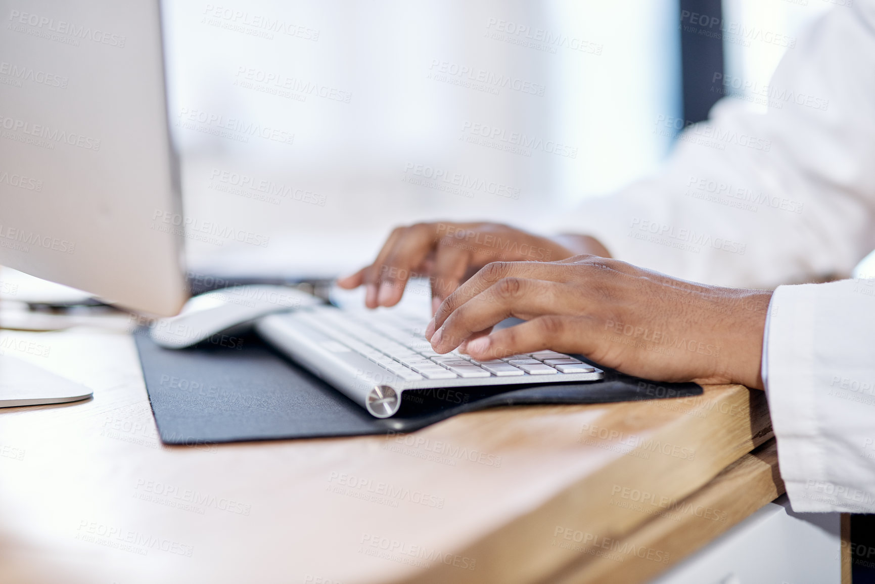 Buy stock photo Closeup shot of an unrecognisable doctor working on a computer