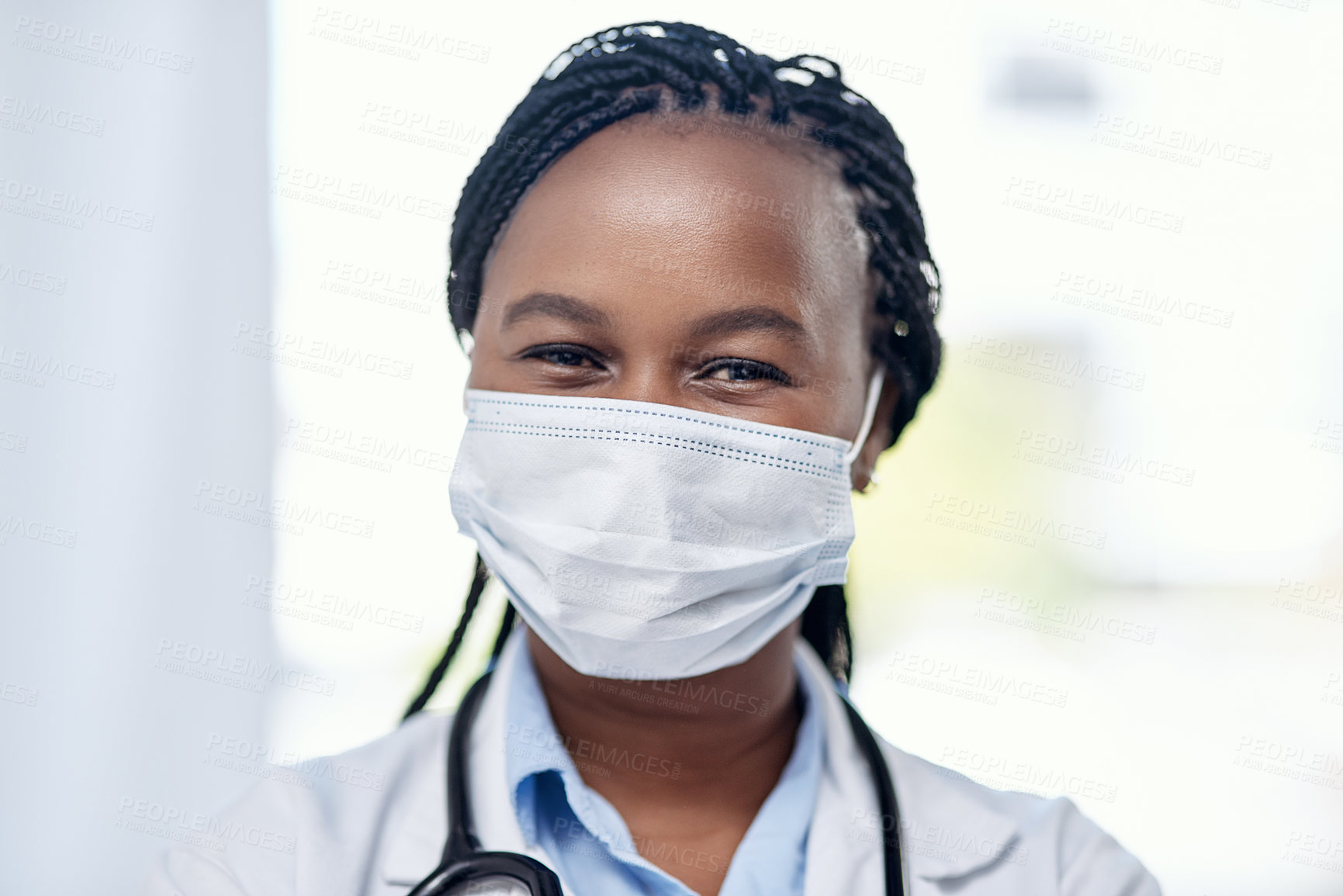 Buy stock photo Portrait of a young doctor wearing a face mask while working in a hospital