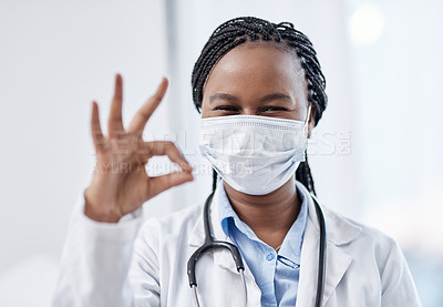 Buy stock photo Doctor gesturing okay hand sign, symbol and emoji to express success and agreement in a good clinic or hospital. Portrait of a smiling medical pathologist looking happy after finding a cure for covid