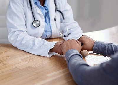 Buy stock photo Closeup shot of an unrecognisable doctor holding hands with a patient during a consultation