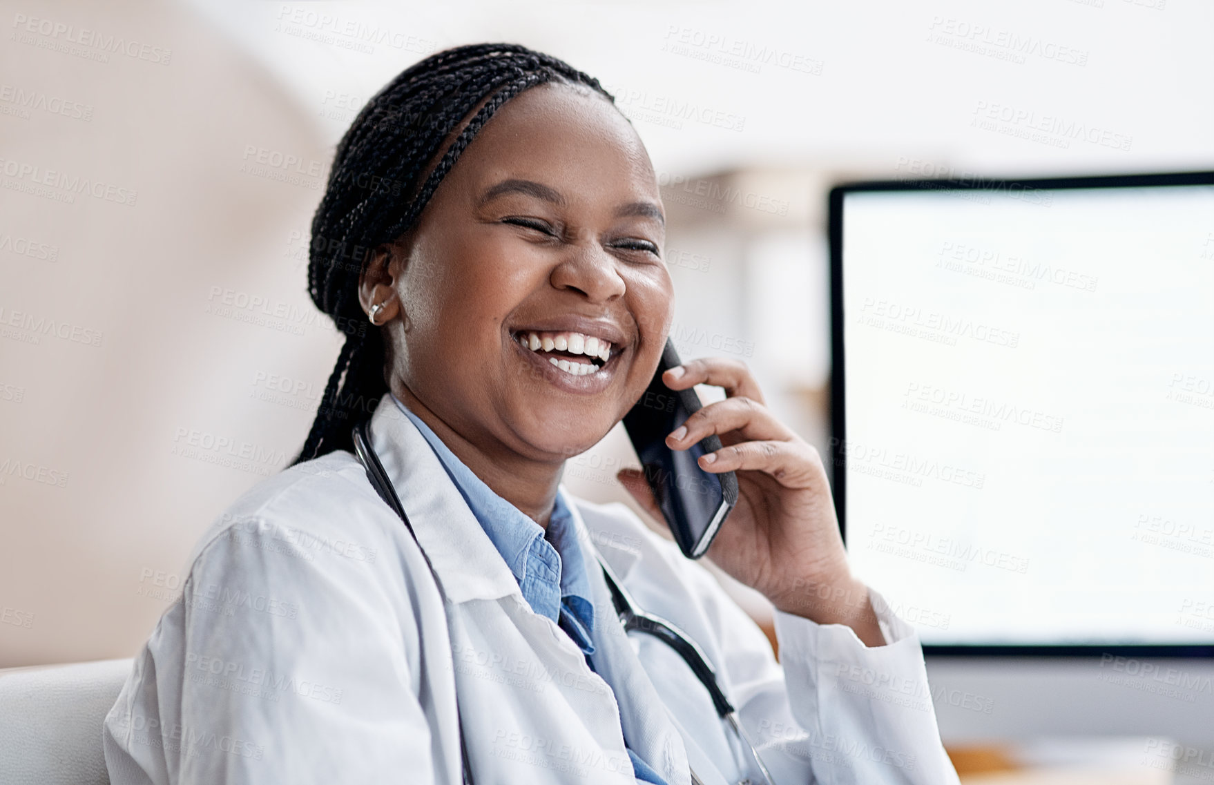 Buy stock photo Shot of a young doctor talking on a cellphone