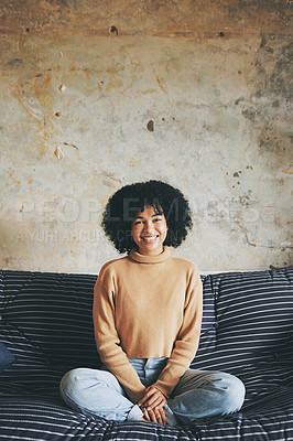 Buy stock photo Portrait of if a young woman relaxing on a sofa at home