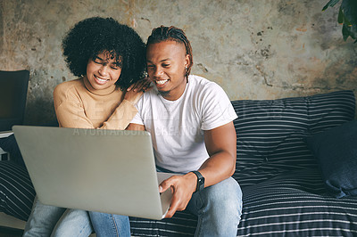 Buy stock photo Shot of a young couple using a laptop together at home