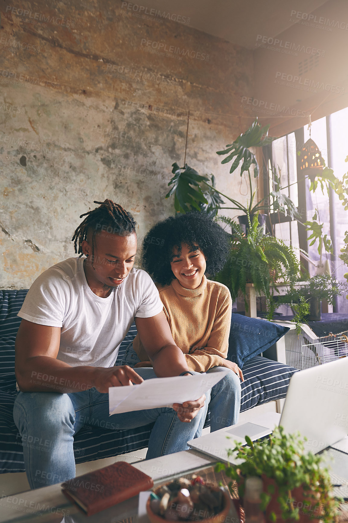 Buy stock photo Home, budget and happy couple on sofa with laptop, rent application or paperwork for tax report. African, man and woman on couch with document, mortgage contract or online app for financial planning