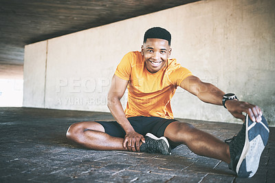 Buy stock photo Portrait of a young man stretching during a workout against an urban background