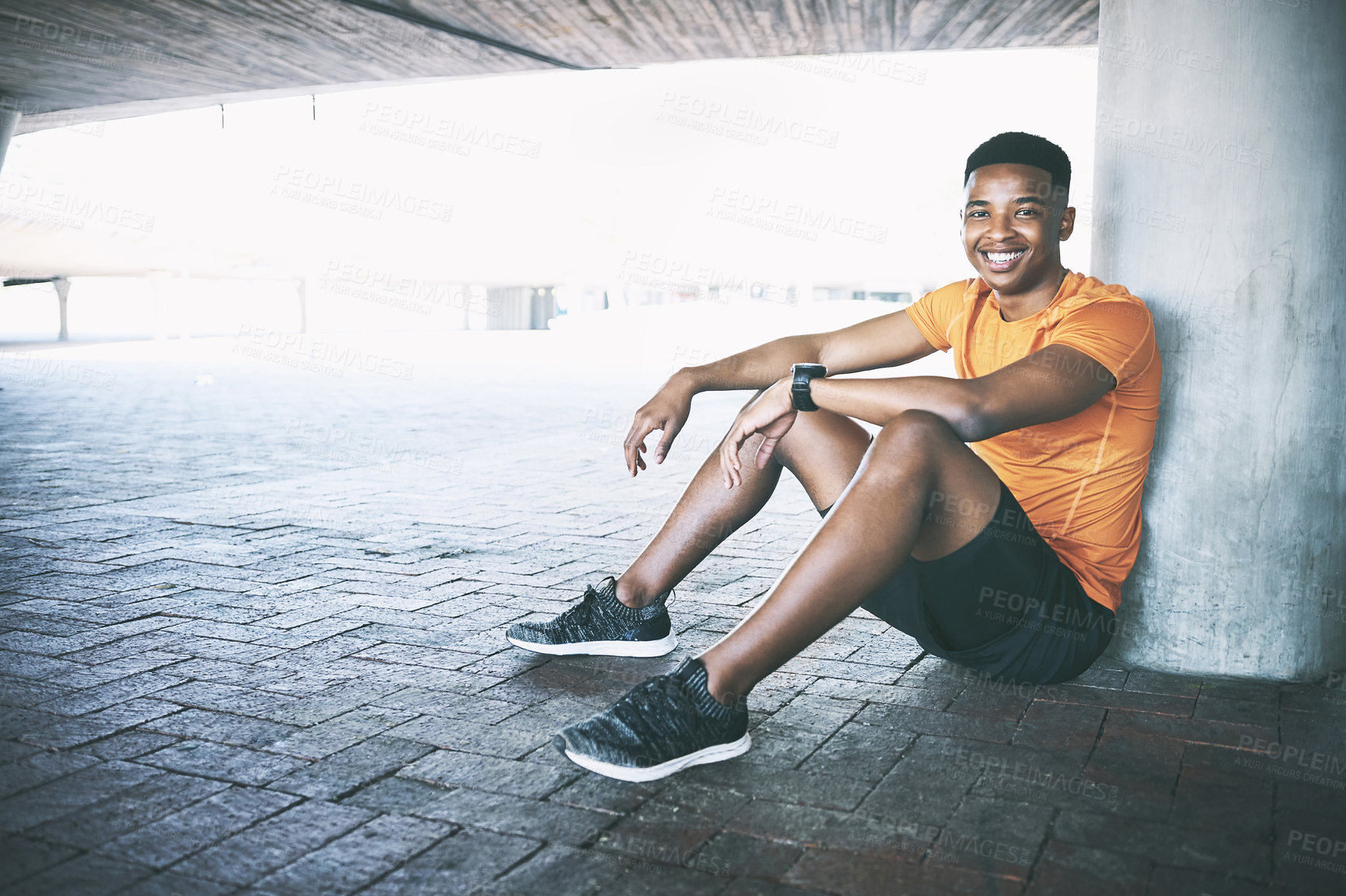 Buy stock photo Portrait of a young man taking a break after working out against an urban background