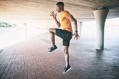 Buy stock photo Shot of a young man jumping during a workout against an urban background