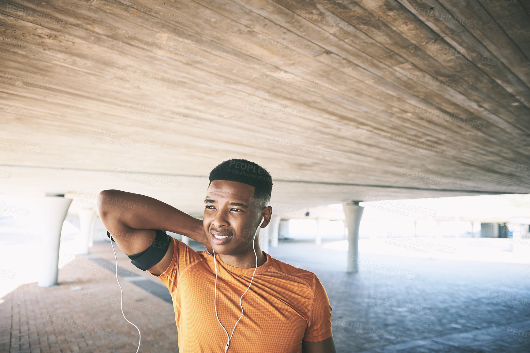 Buy stock photo Shot of a young man experiencing neck pain while working out against an urban background