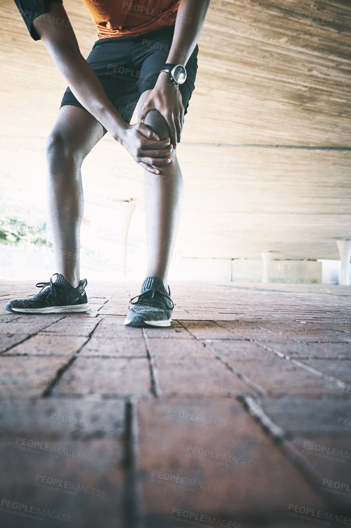 Buy stock photo Cropped shot of a man experiencing joint pain while working out against an urban background