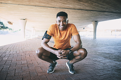 Buy stock photo Portrait of a young man taking a break after working out against an urban background