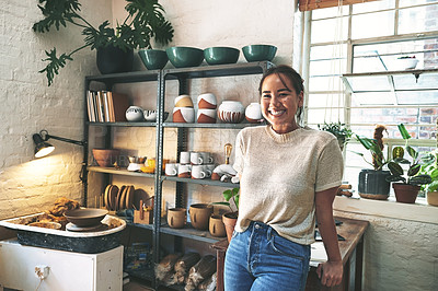 Buy stock photo Cropped portrait of an attractive young business owner standing alone in her pottery studio during the day