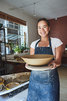 Buy stock photo Shot of a young woman making a bowl in a pottery studio
