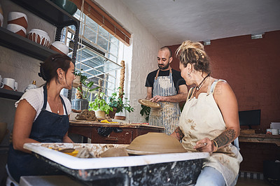 Buy stock photo Shot of a group of young people working with clay in a pottery studio