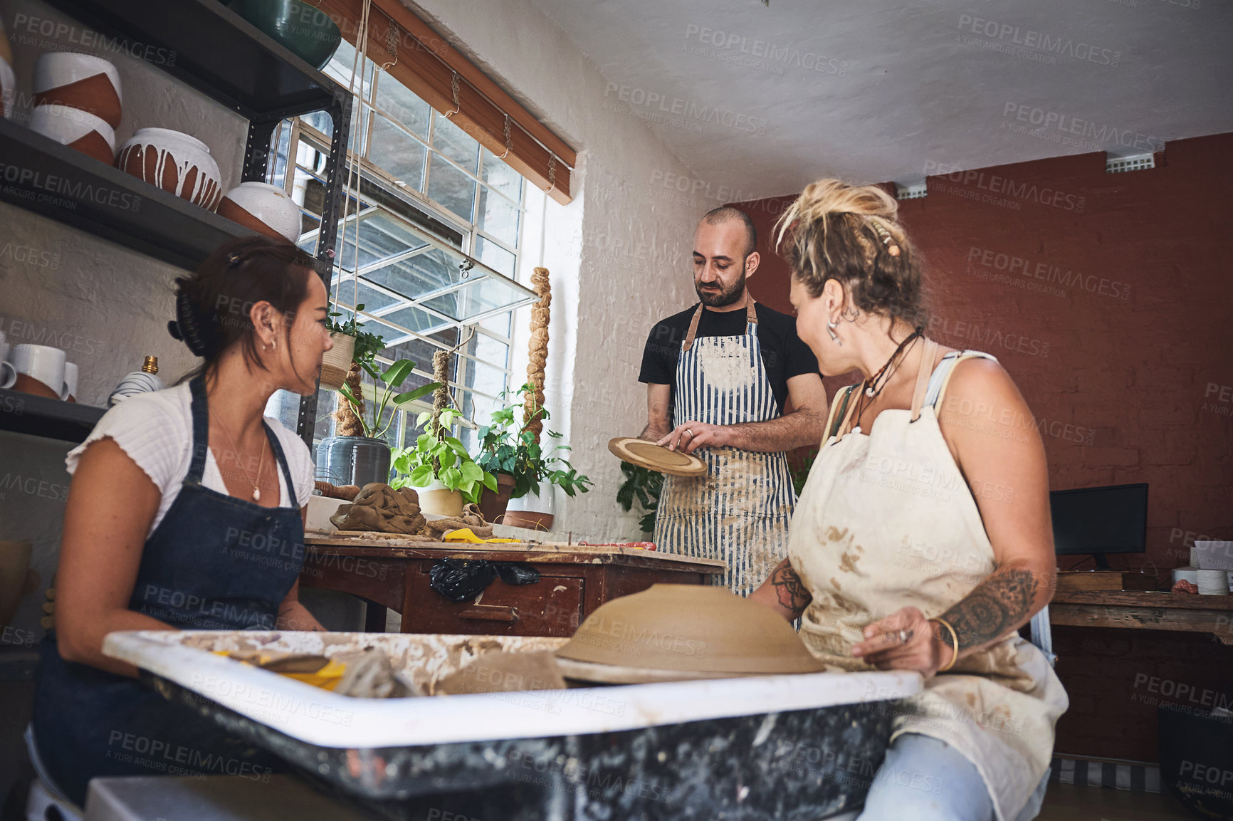 Buy stock photo Workshop, people and teamwork with creativity for pottery, handmade product and skills for design. Small business, colleagues and potter with teaching for mold process, production and collaboration