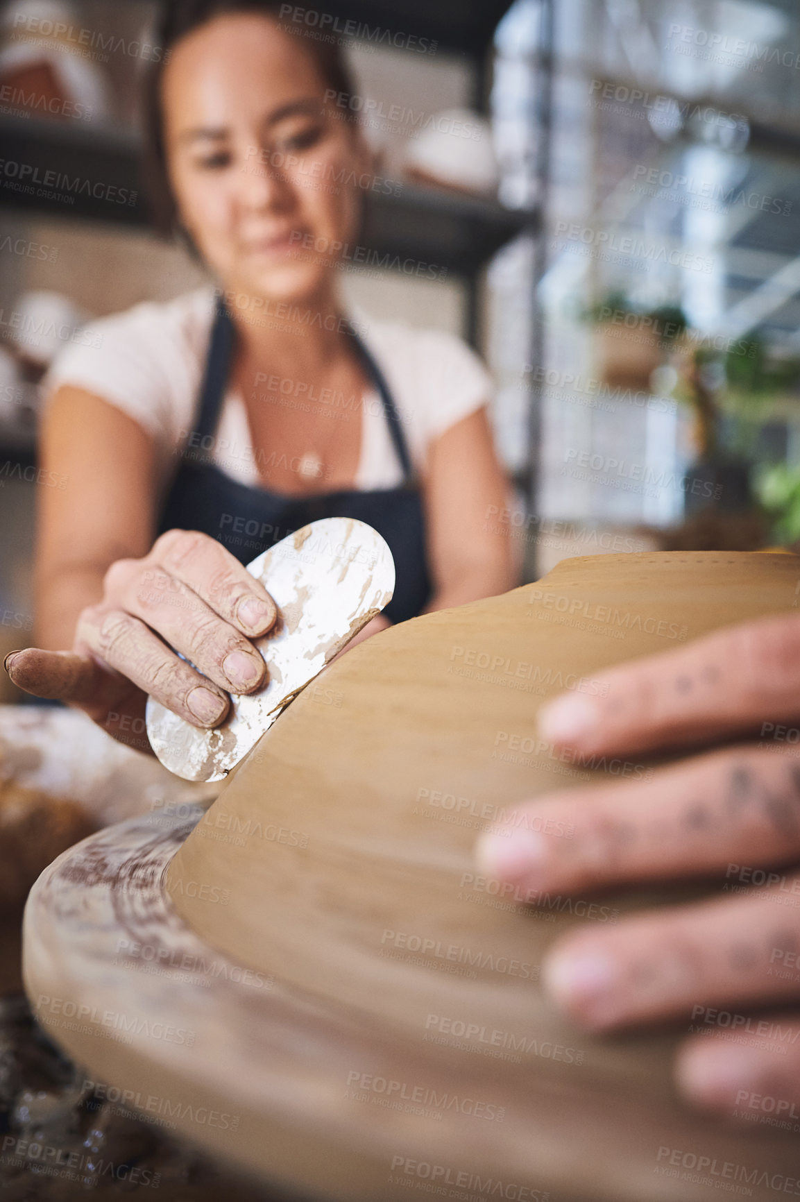 Buy stock photo Shot of two young women working with clay in a pottery studio