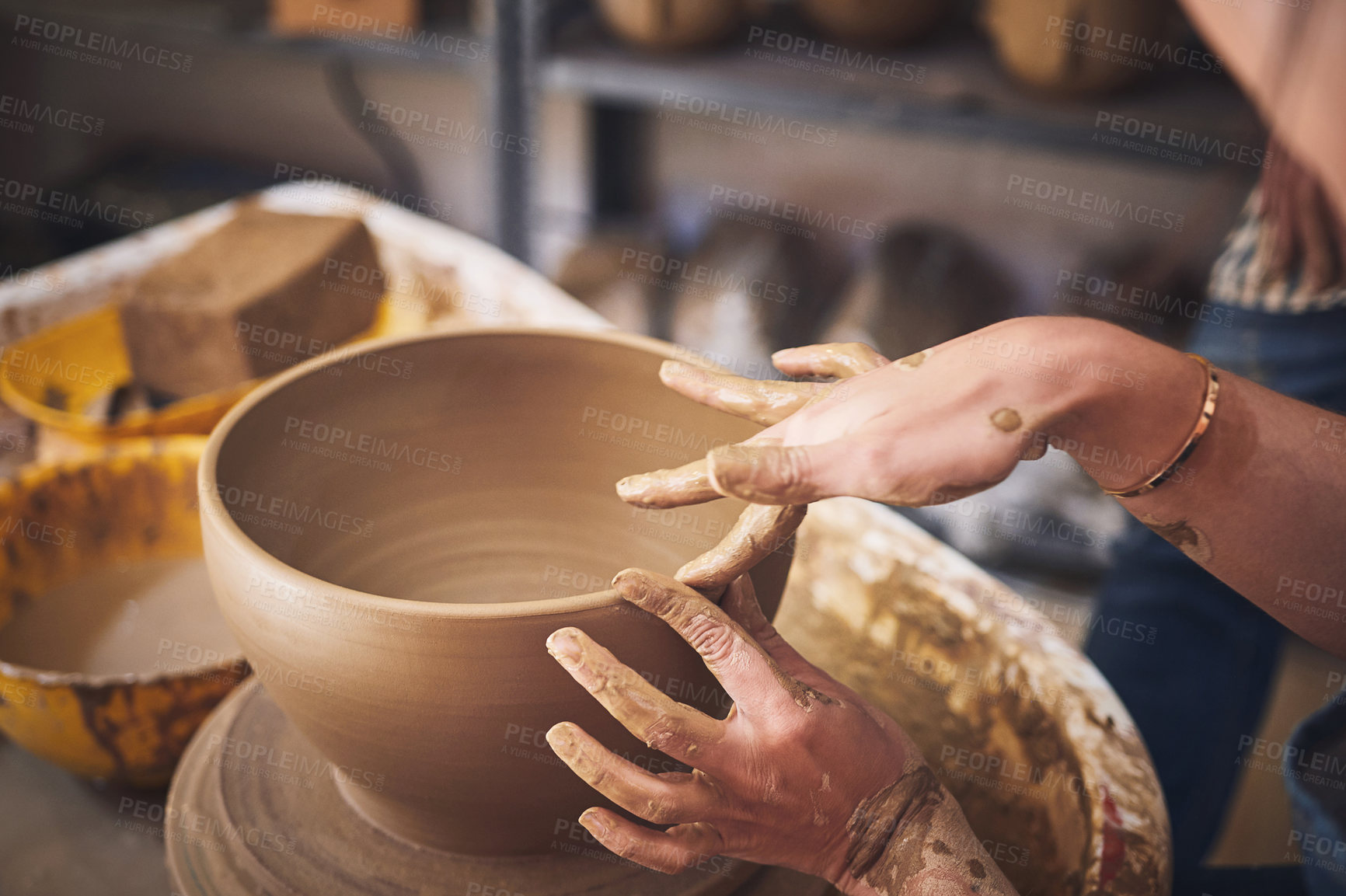 Buy stock photo Shot of an unrecognisable woman working with clay in a pottery studio