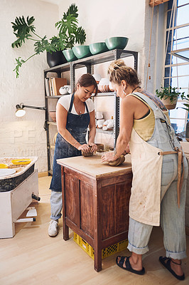 Buy stock photo Women, teaching and clay in studio for pottery, guide and development with learning for new skill. People, mentor and talking with mold, craft and design with art, sculpture or creativity in workshop