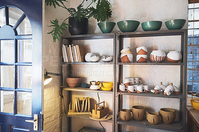 Buy stock photo Shot of various vases and pots on a shelf in a pottery studio