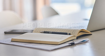 Buy stock photo Closeup shot of a laptop and notebook on a desk in an office
