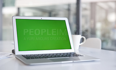 Buy stock photo Shot of a laptop with a green screen on a desk in a modern office