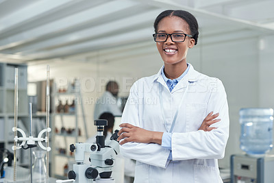 Buy stock photo Portrait of a young scientist standing with her arms crossed in a lab