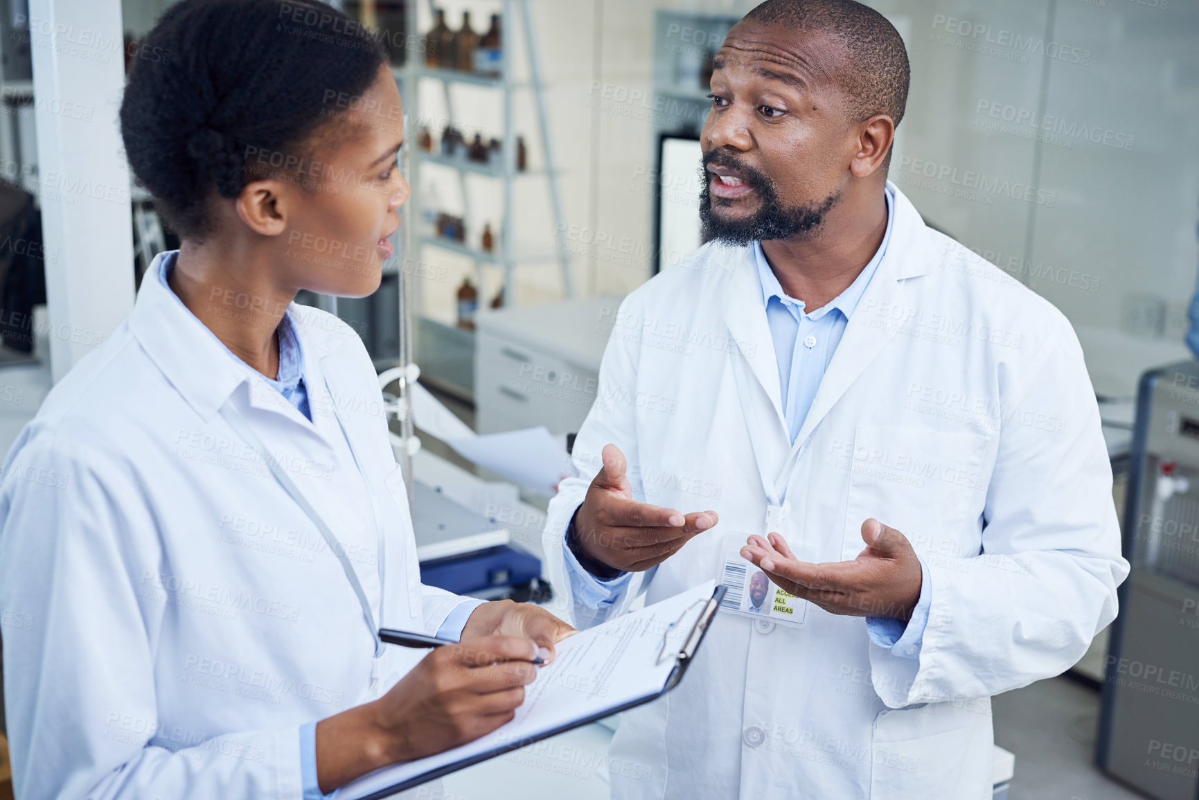 Buy stock photo Shot of two scientists having a discussion in a lab