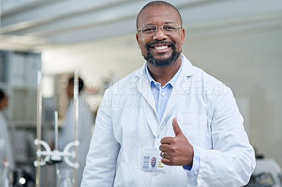 Buy stock photo Portrait of a mature scientist showing thumbs up in a lab