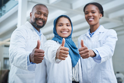 Buy stock photo Portrait of a group of scientists showing thumbs up in a lab